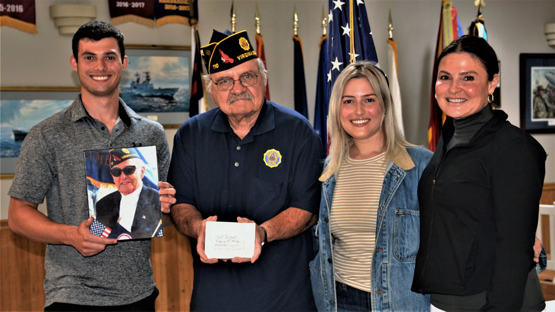 The Staff Sergeant Robert C. Melberg, U.S. Army, American Legion Post 110 of Virginia Beach, VA welcomed Mea Melberg-Rosner and her children, Solomon and Rachel, to it's July 26, 2023 meeting.  Mea is the daughter of Robert C. Melberg, Post 110's namesake, and Solomon and Rachel are his grandchildren.  The Rosner Family made a generous donation to Post 110 and shared personal comments about their father and grandfather.  Accepting the donation for Post 110 was Bob Russell, Finance Officer.  SSGT Melberg fought in WWII's 'Battle of the Bulge' in France and Germany and earned two Bronze Stars with Combat V, Purple Heart, Combat Infantryman Badge, Army Good Conduct Medal and various service and campaign medals.  In the photo (left to right) are Solomon (holding a photo of his grandfather), Bob Russell, Rachel, and Mea Melberg-Rosner.  (Photography by Bert Wendell, Jr.)
