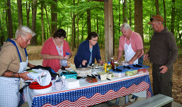 Preparing the picnic table with food and condiments are (left to right) Vicky Wendell, Tonya Jones, Dale Smith, Ron Basso and Woody Wendell. (Photography courtesy of Bert Wendell, Jr.)