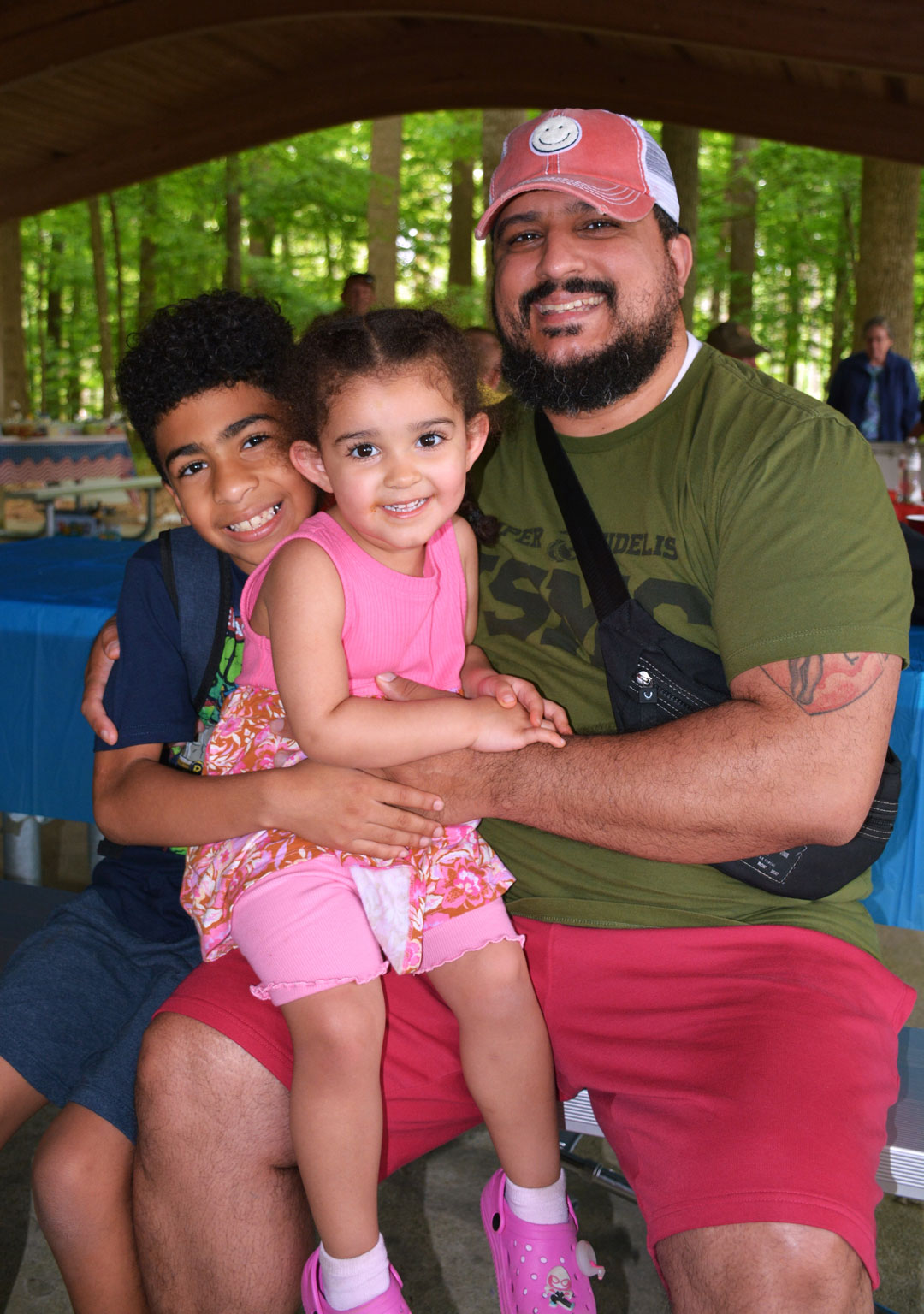Johuanny Torres brought his children to the picnic.  They had a great time playing in the park. (Photography courtesy of Bert Wendell, Jr.)