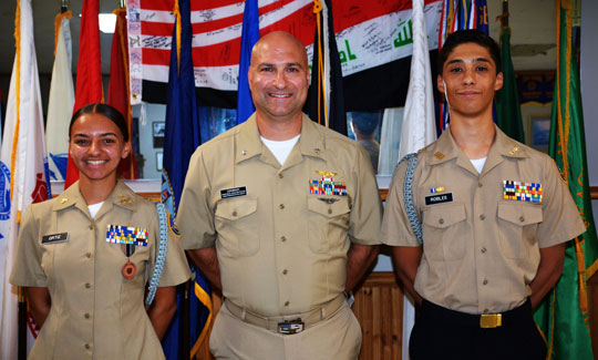 Landstown and Cox/First Colonial High School's NJROTC Units gave presentations to members of the SSgt Robert C. Melberg, U.S. Army, American Legion Post 110 of Virginia Beach, VA on August 28 and September 25, 2024, respectfully.  Each unit's representatives talked about their backgrounds, achievements and future goals.  Depicted (left to right) Cadet Christina Ortiz, Cdr. Bill Brody, USN (Retired) and Cadet Raymond Robles.  (Photography by Bert Wendell, Jr.)