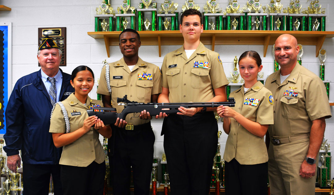 The SSgt Robert C. Melberg, U.S. Army, American Legion Post 110 of Virginia Beach, VA is sponsoring the Landstown H.S. NJROTC Shooting Team for school year 2024-2025.  On October 17, 2024, Post 110 Commander Ron Basso visited with CDR William Brody, USN (Retired), Senior Naval Science Advisor, and with members of the school's shooting team.  The shooting team uses the Crosman Challenger PCP Compressed Air Rifle.  In the photo (left to right) are Post Commander Ron Basso, Cadet LT Ghezel Siloonga, Cadet LT Marlon Harris, Cadet SCPO Evan Cook, Cadet PO3 Ryleigh Morse and CDR Brody.  (Photography by Bert Wendell, Jr.)