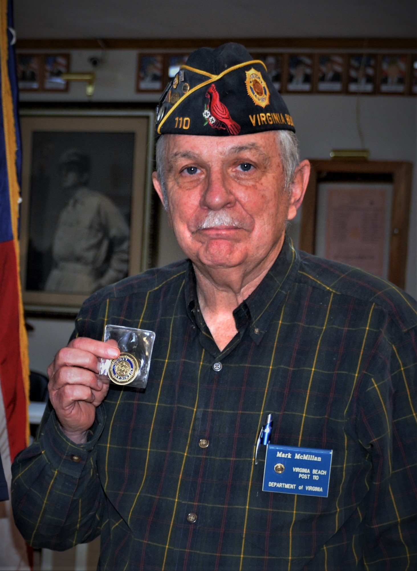 Legionnaire Mark McMillan was recognized for                              his 25 years of membership and service to the                              American Legion at the November 25, 2020 meeting                              of American Legion Post 110 in Virginia Beach,                              VA. Post Commander Rick Jones presented McMillan                              with an American Legion Commemorative Coin.                              McMillan served as Post 110 Commander during                              2006-2007. (Photography by Bert Wendell, Jr.)