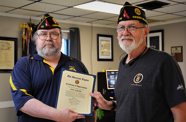 American Legion Post 110 Commander Rick Jones                              (left) presents a Certificate of Appreciation to                              outgoing Post Finance Officer Jon Asher (right)                              for his outstanding Service and Leadership for                              2018-2021. Asher contributed greatly to the                              advancement of The American Legion's programs and                              activities. (Photography by Bert Wendell,                            Jr.)