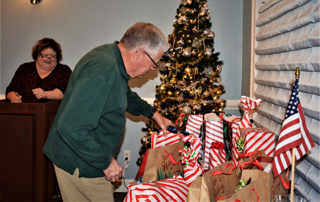 Gift Photo:  Dave Smith selects his gift after his number was called by Tonya Jones. (Photography by Bert Wendell, Jr.)