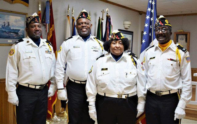 Colonel Otha Newton, American Legion, Department of Virginia, Second District Honor Guard, gave a presentation on his unit before members of American Legion Post 110 in Virginia Beach, VA on February 23, 2022.  Colonel Newton spoke about how the Honor Guard was founded, the duties they reform in support of military veterans and the community, and the urgent need to recruit new members to serve in the Honor Guard. At the meeting, the Honor Guard also posted and retrieved the U.S. Flag, the American Legion Flag, and placed the POW/MIA Flag on the empty chair.  In the photo (left to right) are:  Steven Gipson (Post 327), Amos Harvey (Post 60), Helen Lynum (American Legion Auxiliary of Post 327) and Colonel Newton (Post 327). (Photography by Bert Wendell, Jr.)
