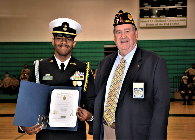 Fred Kinkin (right), adjutant for American Legion Post 110, presented The American Legion JROTC Military Excellence Medal and Certificate to Cadet Lieutenant De' Angelo Bailey (left) at ceremonies held on May 10, 2022 at Frank W. Cox High School, Virginia Beach, VA.  Absent from the photo was Cadet Seaman Kathirine Urrurita who earned the Scholastic Excellence Award. (Photography by Bert Wendell, Jr.)