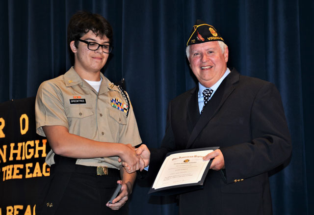 Ron Basso (right), legionnaire of American Legion Post 110, presented The American Legion JROTC Medals and Certificates to cadets at Landstown High School, Virginia Beach, VA on May 11, 2022.  Cadet Jacob Greentree (left), receives the Scholastic Excellence Award. (Photography by Bert Wendell, Jr.)
