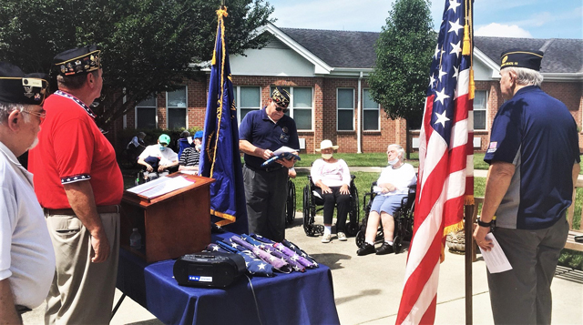 Clifford Dietz (center), vice commander of                              American Legion Post 113 and ceremony Sergeant at                              Arms, prepares to present a tattered and worn                              American Flag for a final inspection at the 2021                              Flag Day Ceremony which was held on June 14th at                              Our Lady of Perpetual Help in VA. Beach, VA.                              (Photography by David Smith)